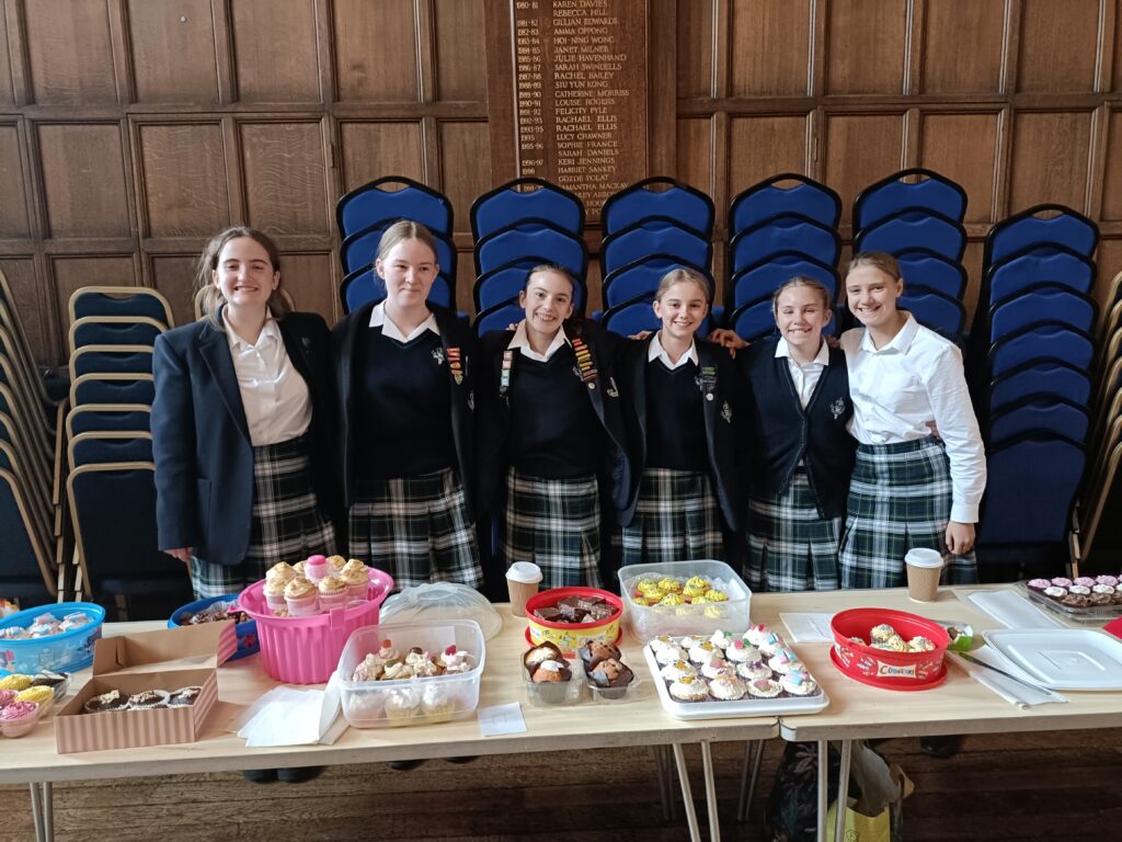 Girls next to the bake sale for children in need